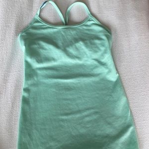 Ivivva tank top, kids size 7. Color is mint green with purple thread.
